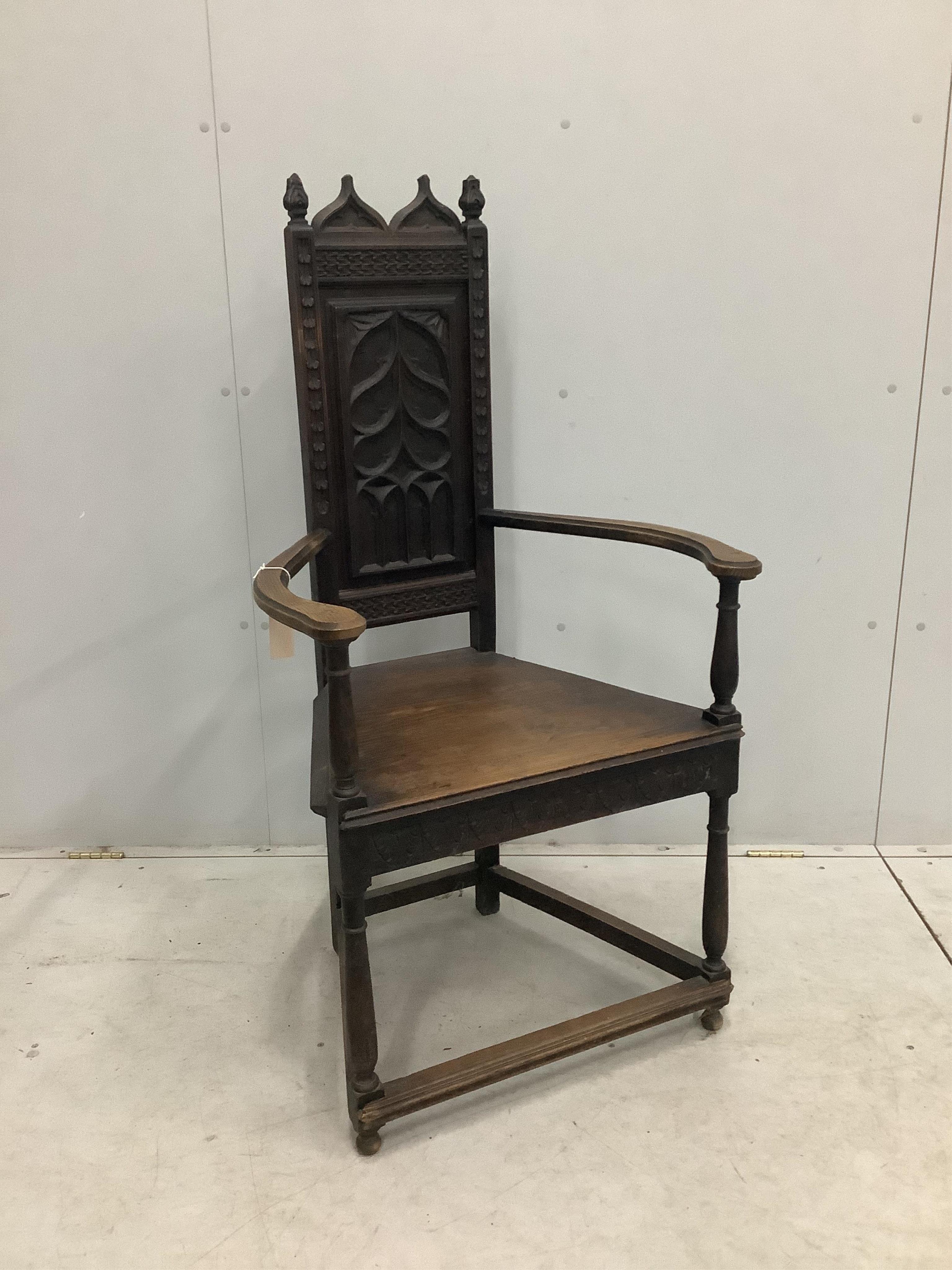 A Continental Gothic Revival oak elbow chair, width 66cm, depth 50cm, height 124cm. Condition - fair